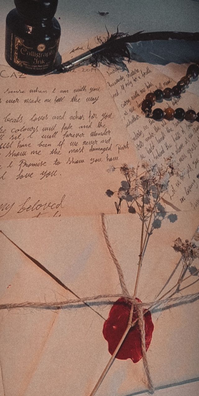 an old letter with writing on it next to a pen and ink well used by the writer