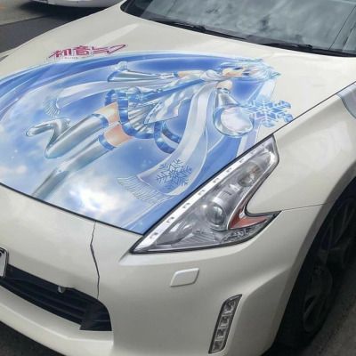 a white car with an anime theme painted on it