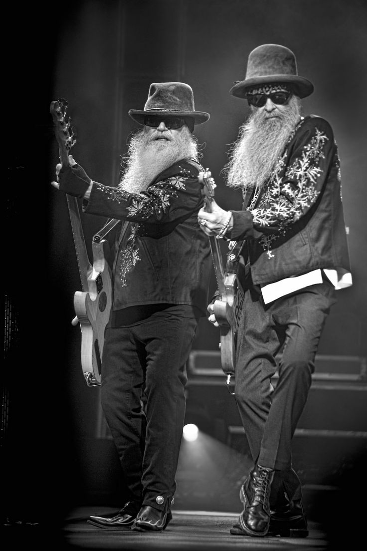 two men with long white beards are holding guitars and standing next to each other