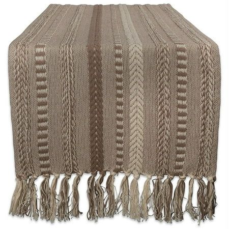 a blanket with fringes on top of it