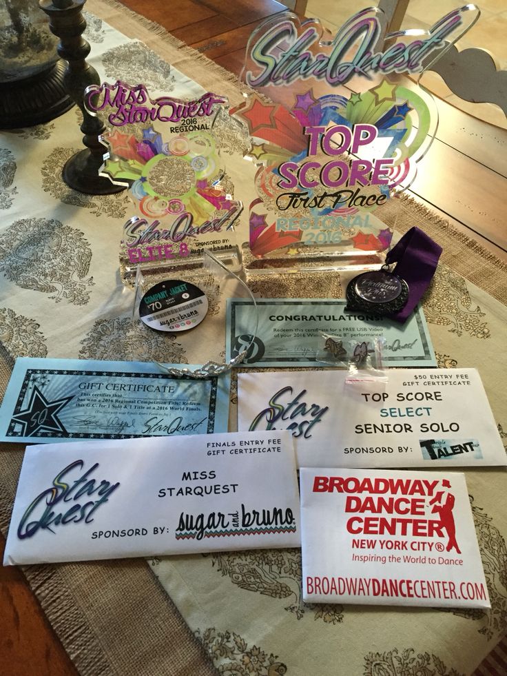 several awards are sitting on a table with paper and other items in front of them