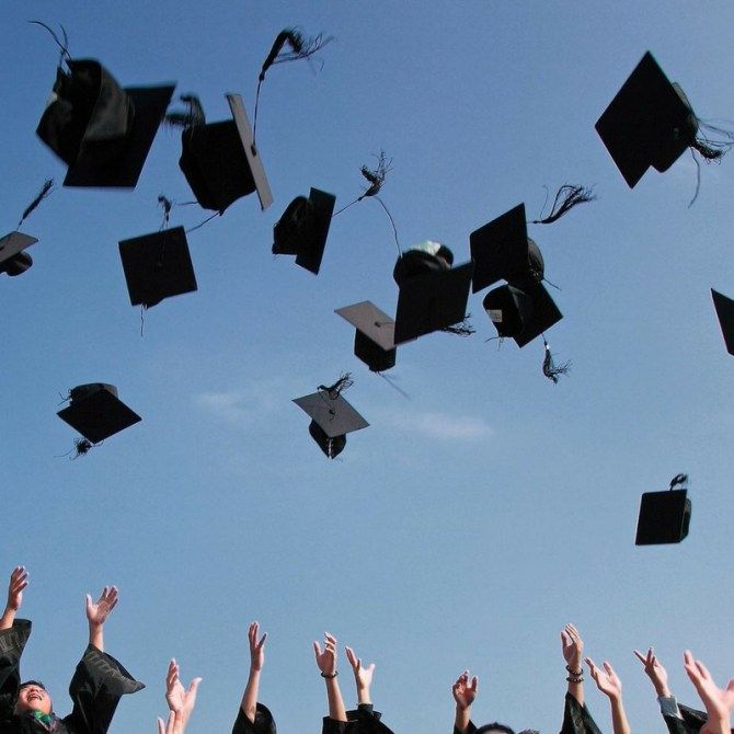 graduates throwing their caps in the air