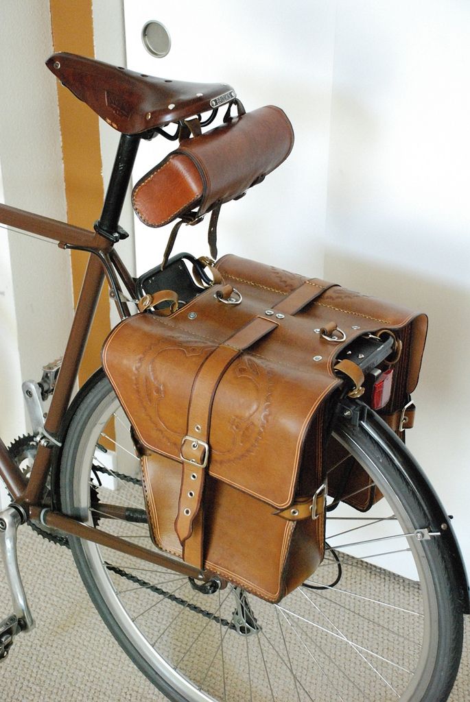 a bicycle with a leather saddle on the back