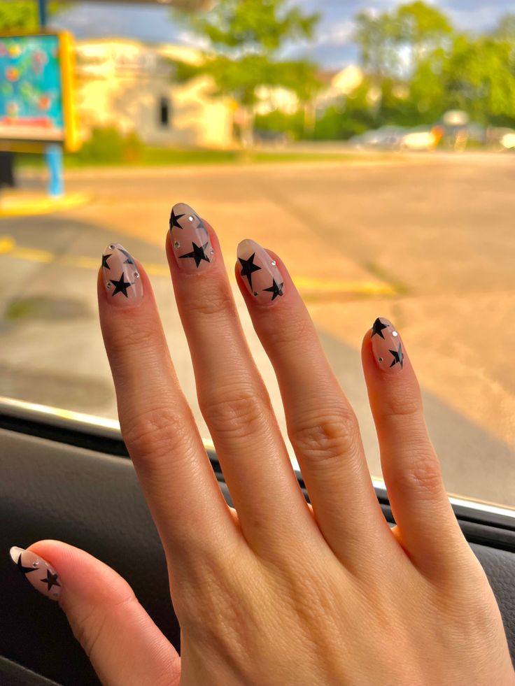 Oval Nails Star Design, White Star Almond Nails, Medium Length Star Nails, Clear Nails With Black Stars, Short Stars Nails, Nails Acrylic Almond Stars, Short Aesthetic Almond Nails, Sparkly Nails With Stars, Nail Ideas Y2k Short Almond