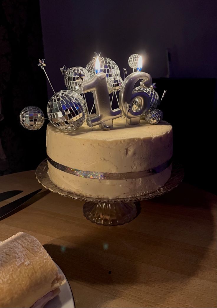 a cake that has some candles on top of it and is sitting on a table