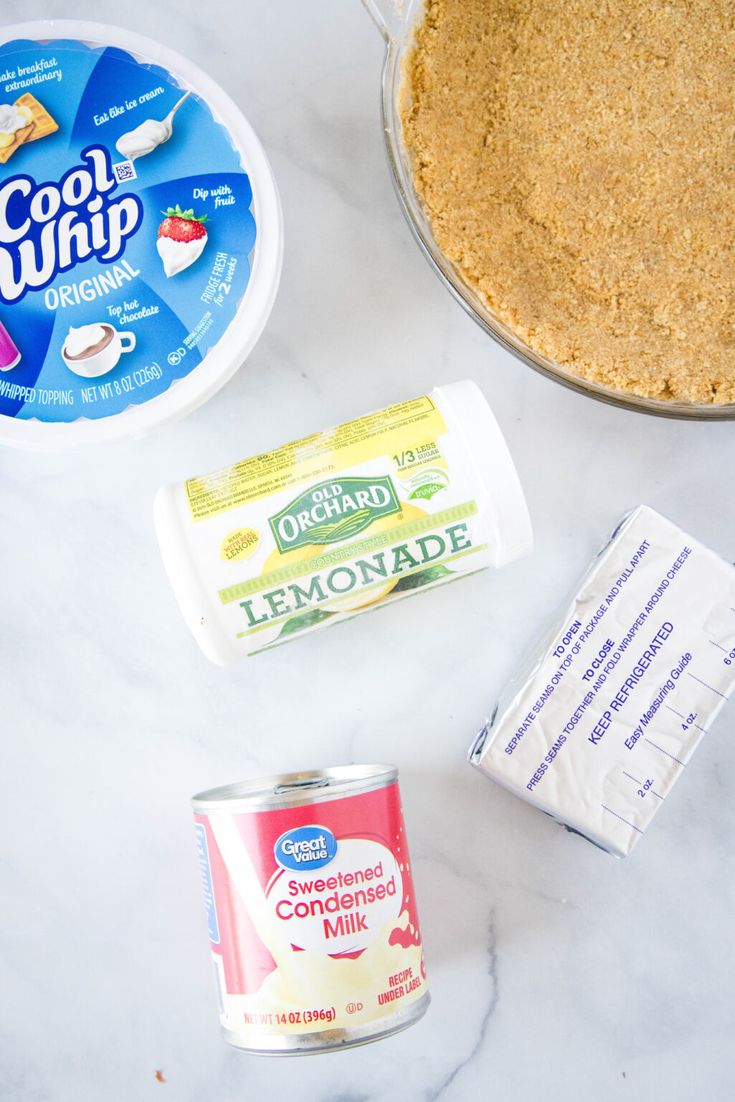 ingredients to make lemonade cake sitting on a counter top next to a pie pan