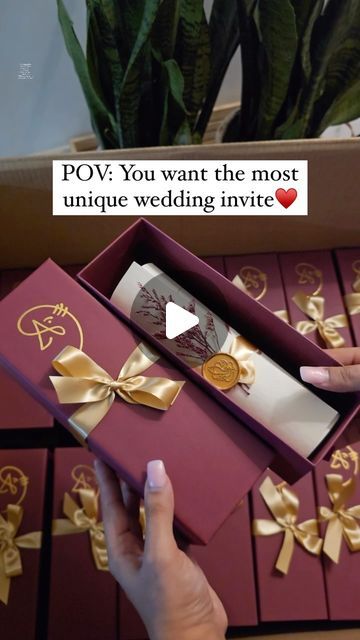 a person holding a box that is open and has gold ribbon around it, with the caption pov you want the most unique wedding suite