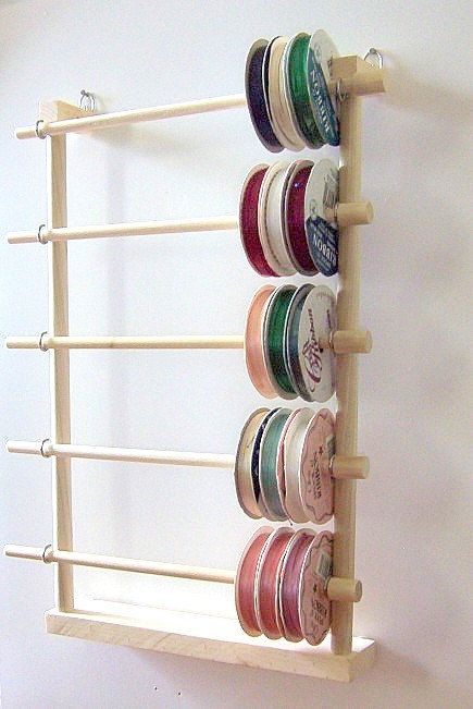 a wall mounted cup holder with several cups on it