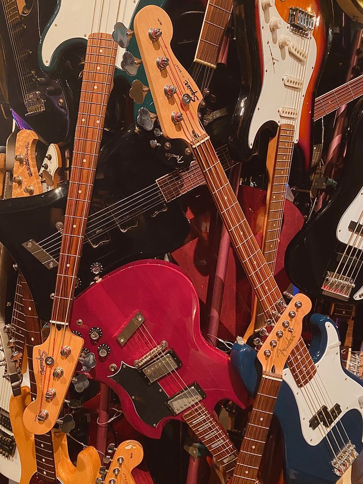 a pile of guitars sitting next to each other