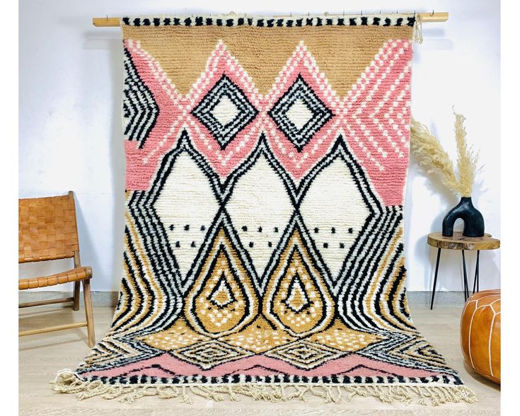 a large rug is displayed in front of a chair