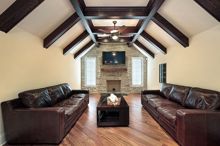 a living room filled with furniture and a flat screen tv mounted on the wall above a fireplace