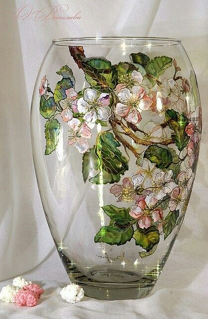 a glass vase with flowers painted on it