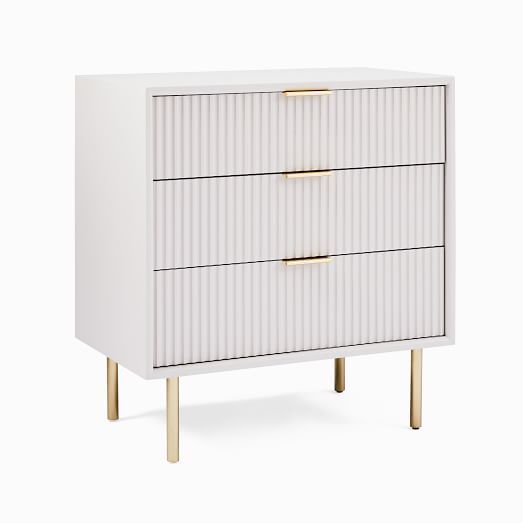 a white and gold dresser with two drawers on one side, the top drawer is closed