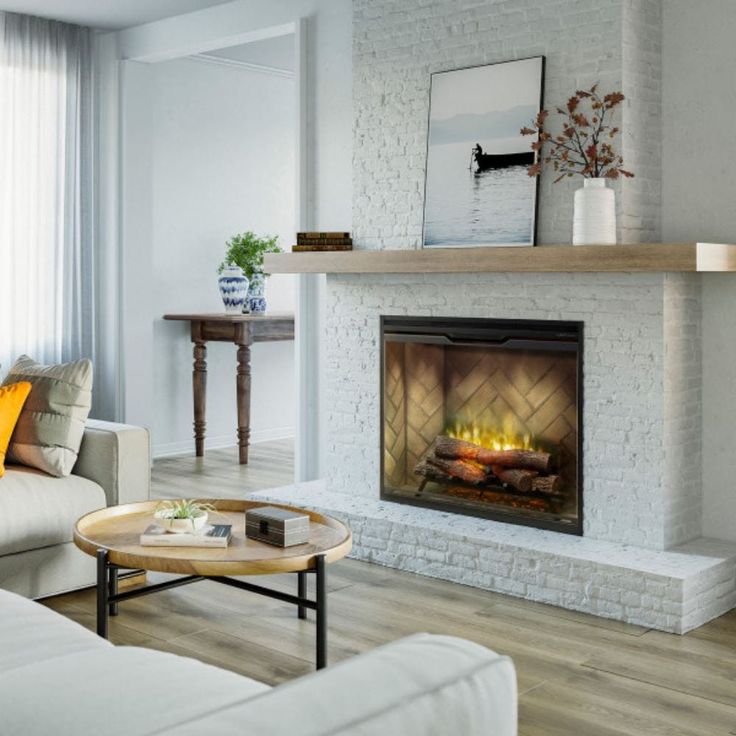 a living room with a fire place next to a couch and coffee table in front of a window