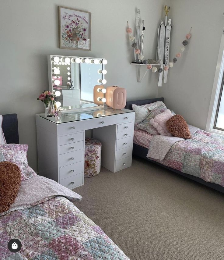 a bedroom with two beds and a vanity