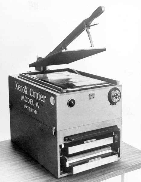 a black and white photo of an xerox copier machine on a table