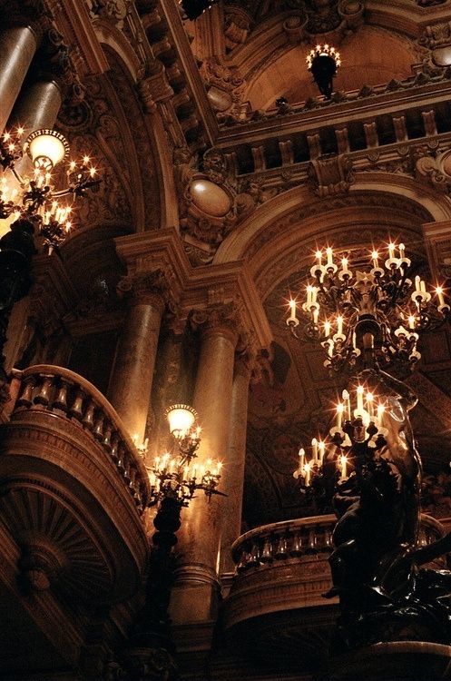 the chandeliers are hanging from the ceiling in this ornately decorated building,