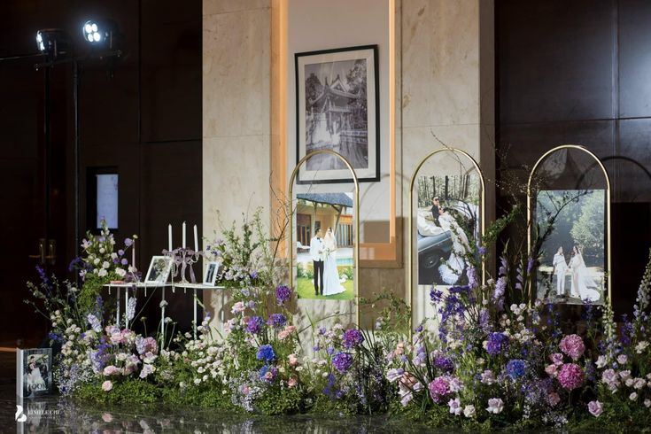 flowers and pictures are on display in front of a building