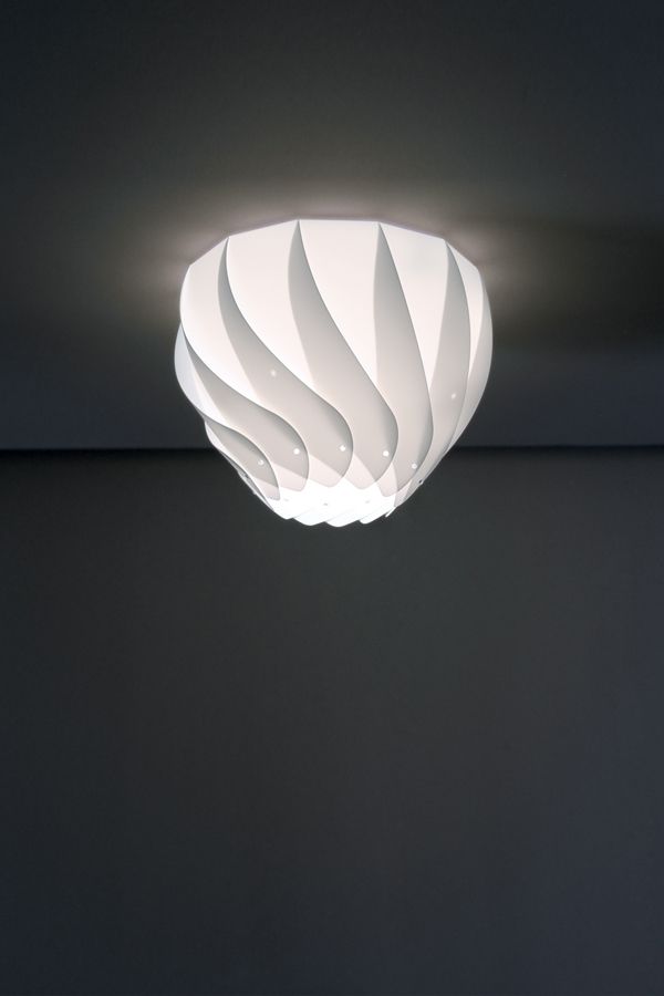 a white ceiling light hanging from the ceiling in a room with dark walls and flooring