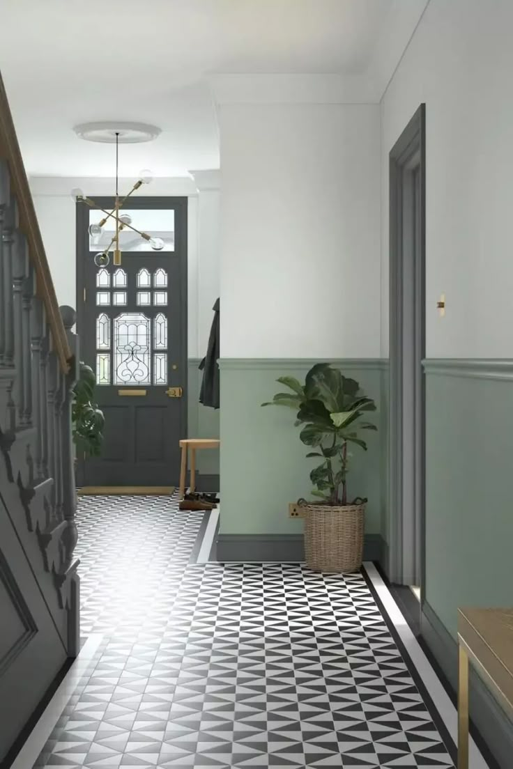 an entryway with black and white checkered flooring, potted plant on the far side