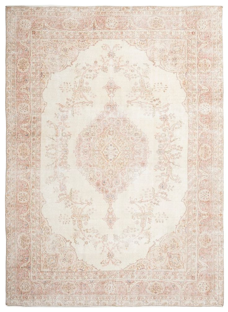 an antique rug with pink and white colors