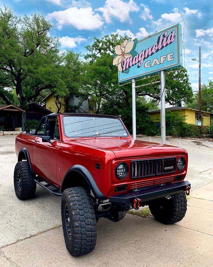 a red truck parked in front of a cafe