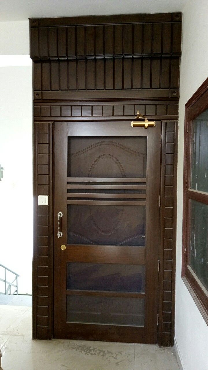 a wooden door in the corner of a room