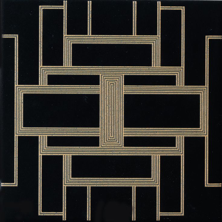 a black and gold tile with an intricate design