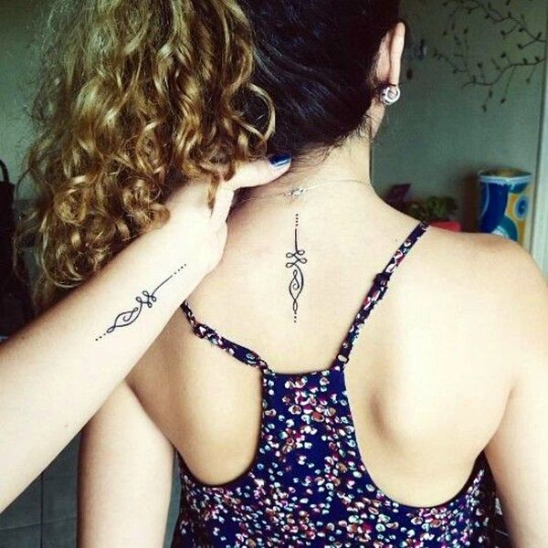 a woman with a cross tattoo on her back