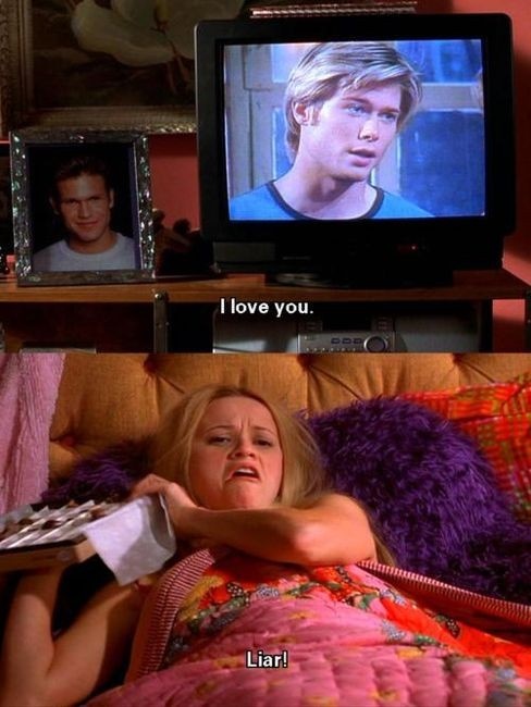 a woman laying in bed next to a tv with the caption me on valentine's day