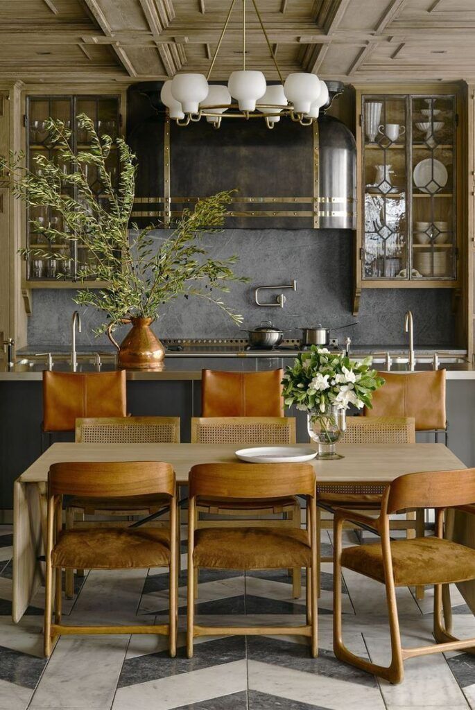 a dining room table surrounded by chairs and vases