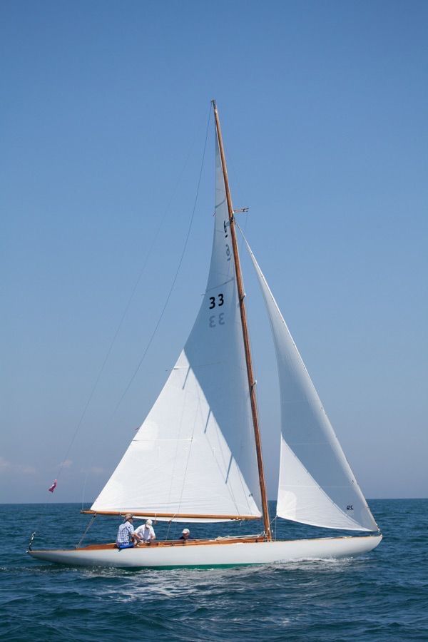 a sailboat with two people on it in the ocean