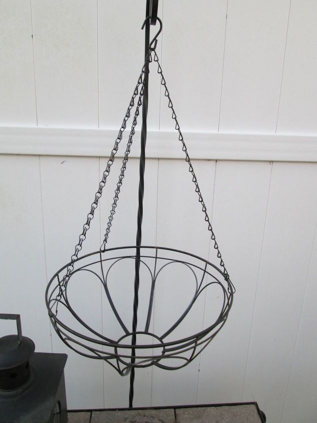 a metal basket hanging from the side of a wall