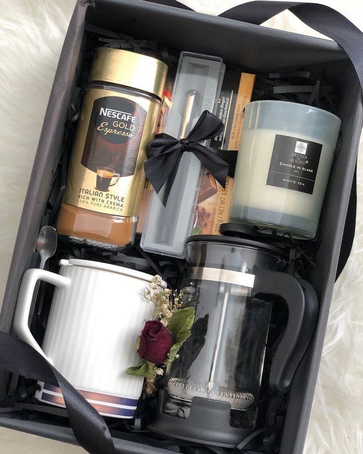 an open box containing coffee, candles and other items