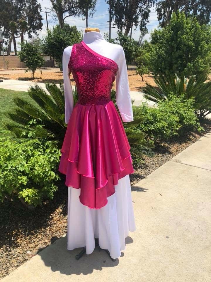 a pink and white dress sitting on top of a sidewalk