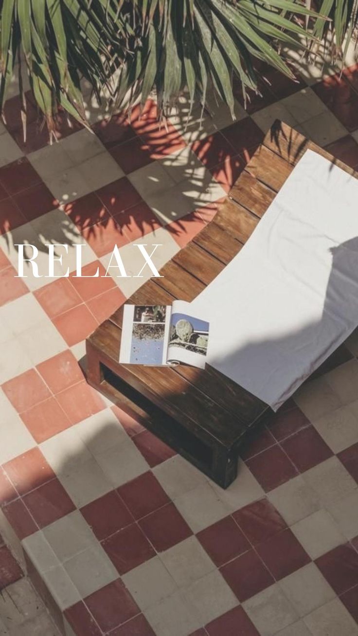 a table with a magazine on it sitting in the middle of a checkered floor