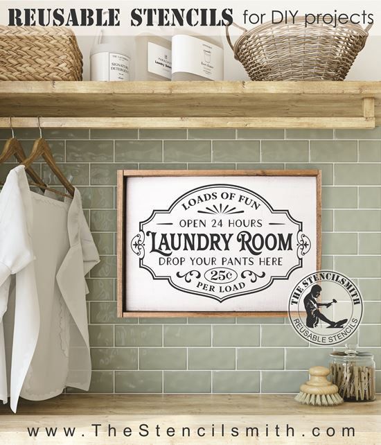 a laundry room sign hanging on the wall above a shelf with towels and ...