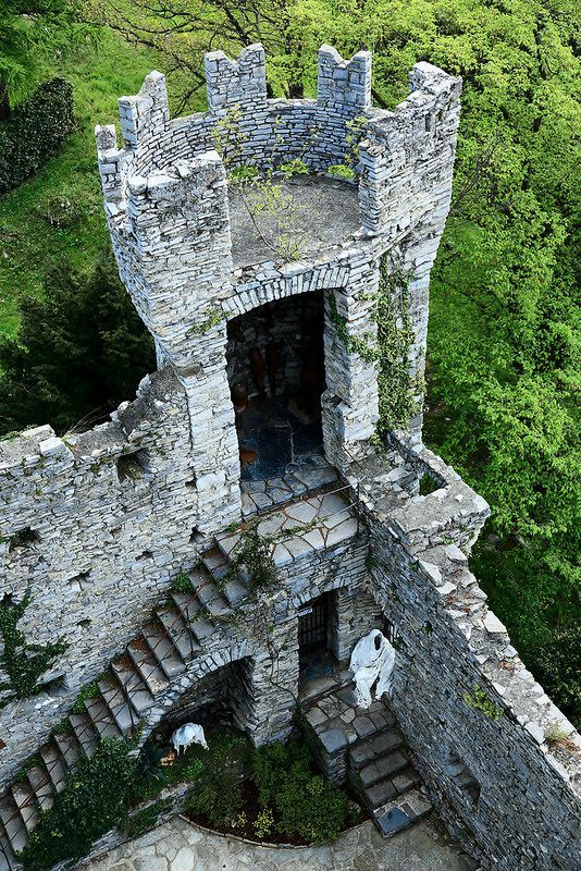 an aerial view of a stone castle with stairs leading up to the door and windows