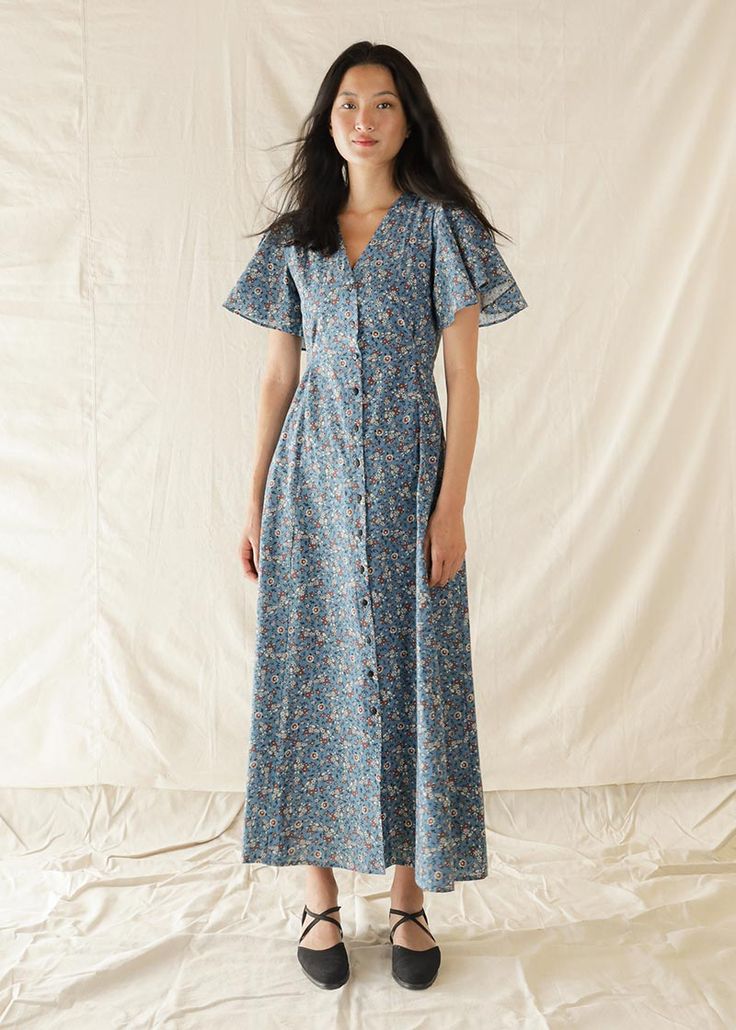 Atèlette - Blue Floral Cotton Button Down Cape Sleeve Maxi Dress - JEANNE - Sustainable Women's Clothing Sustainable Womens Clothing, Chore Coat, Knit Bottom, Cape Sleeves, Jane Birkin, Blue Floral Print, Made Clothing, 70s Inspired, Clothes Crafts