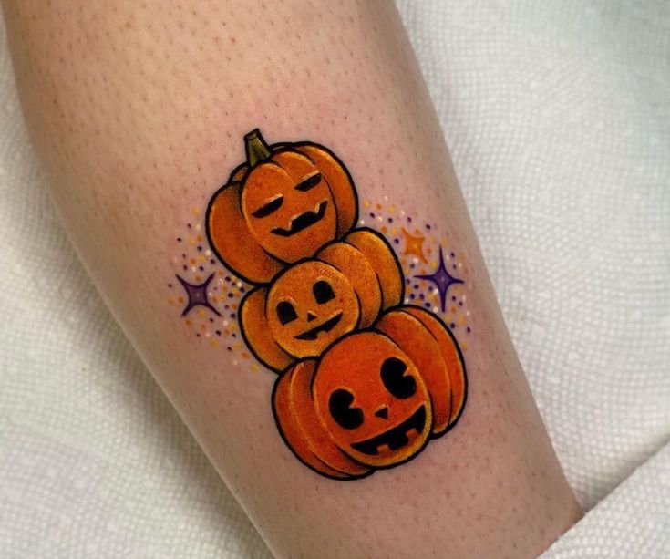 three pumpkins with faces drawn on their legs