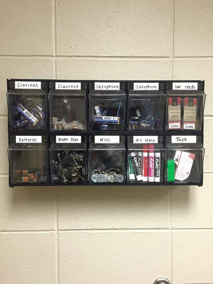 a wall mounted shelf filled with lots of different types of items in bins next to a toilet