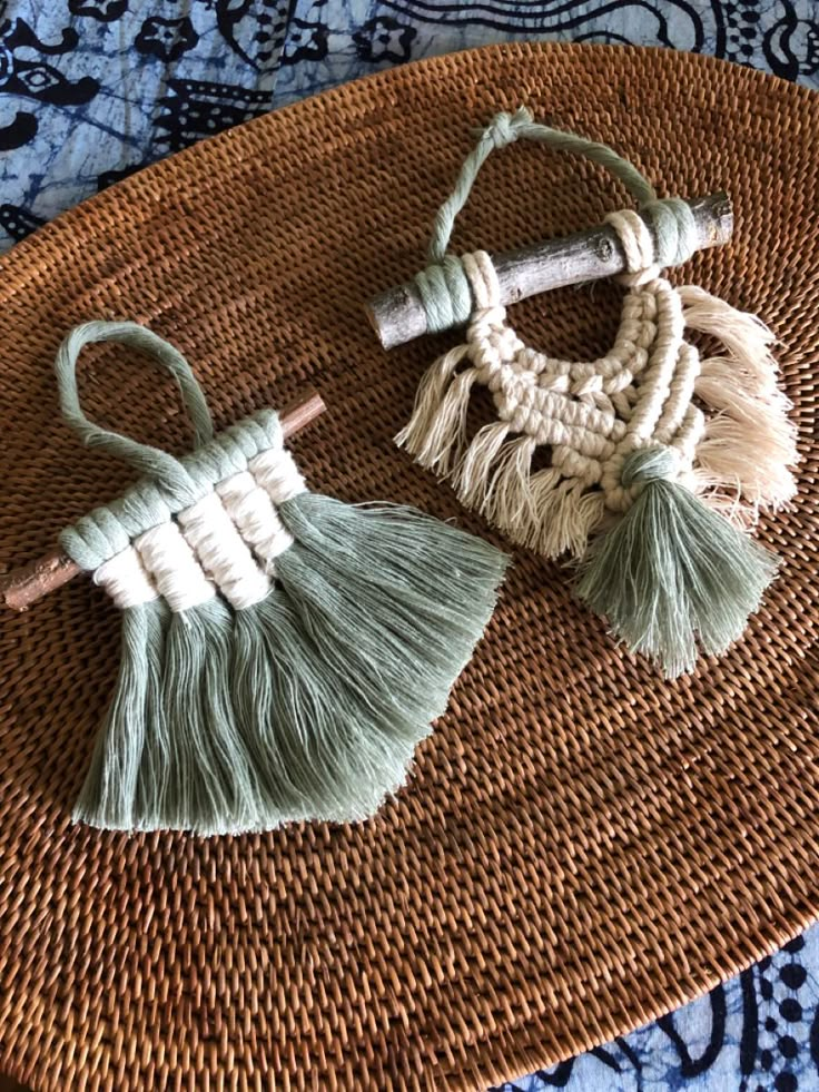 two small tassels sitting on top of a woven mat