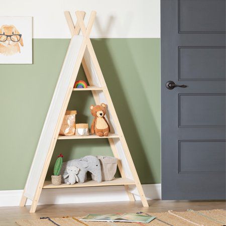 a child's room with a wooden triangle shelf