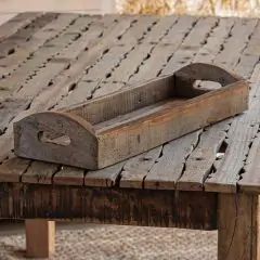 an old wooden table with some sort of tray sitting on it's side,