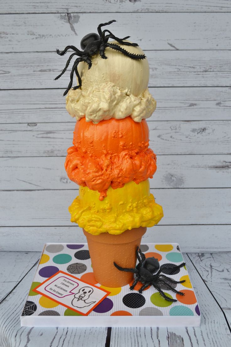 an ice cream cone with halloween decorations on top