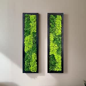 two green paintings on the wall above a bed