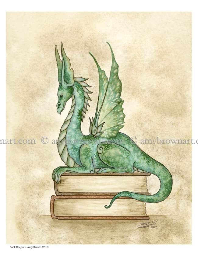 a green dragon sitting on top of a book