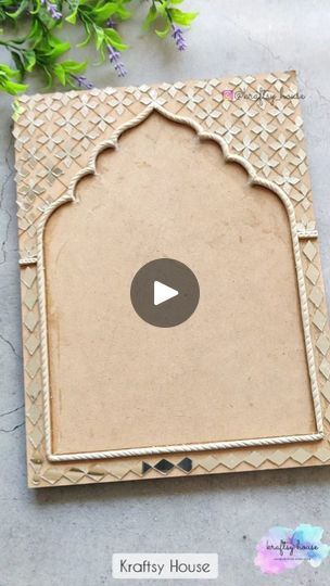 the video is showing how to make an intricate wooden frame with flowers in the background