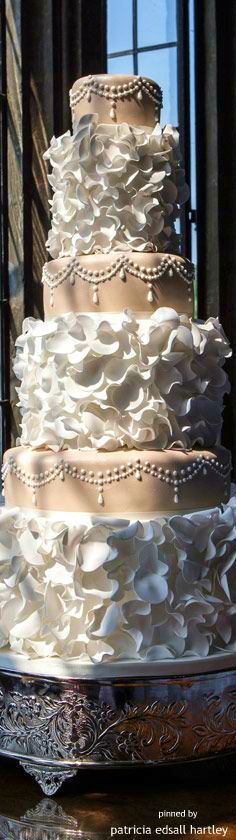 a white wedding cake sitting on top of a table