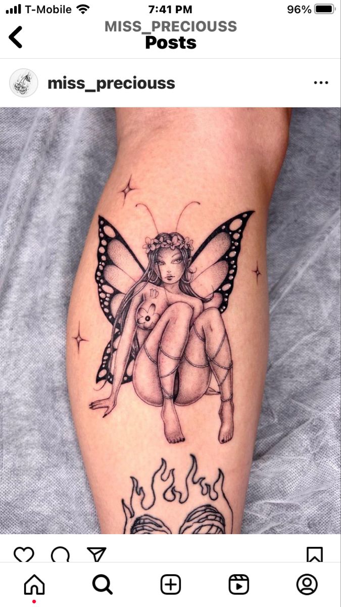 a tattoo on the leg of a woman with a butterfly and fire in her hand